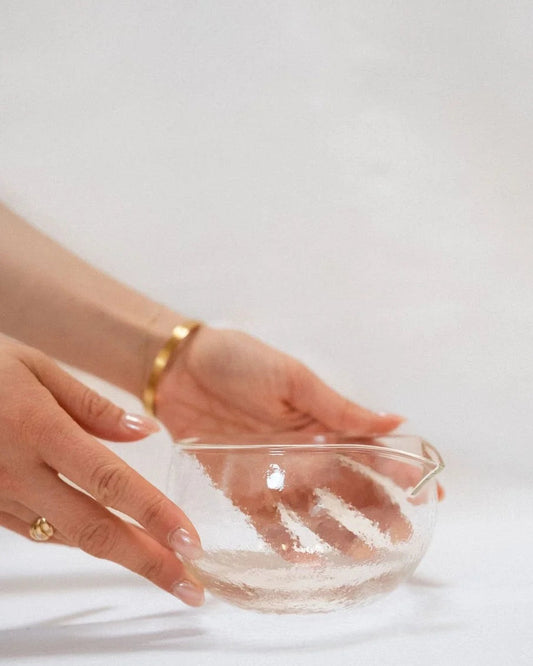 Glass matcha bowl held in hand