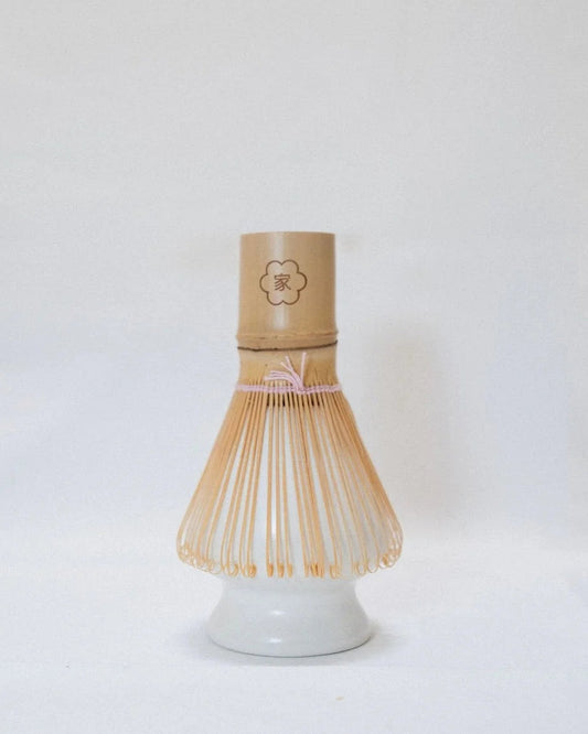 Bamboo matcha whisk on a ceramic stand