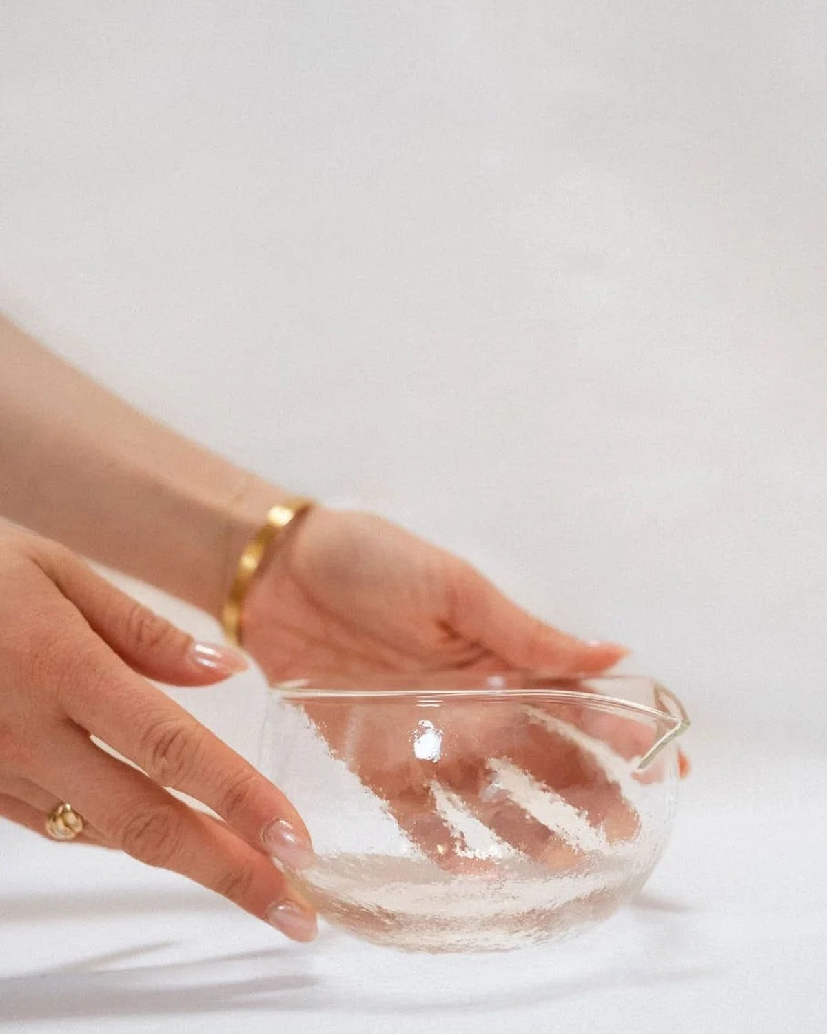 Glass matcha bowl held in hand